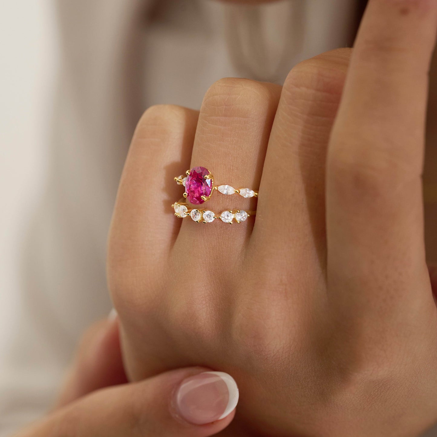 Pink oval gemstone with marquise cubic zirconia pave in 18K gold vermeil stacked with half eternity cubic zirconia ring in 18K gold vermeil.