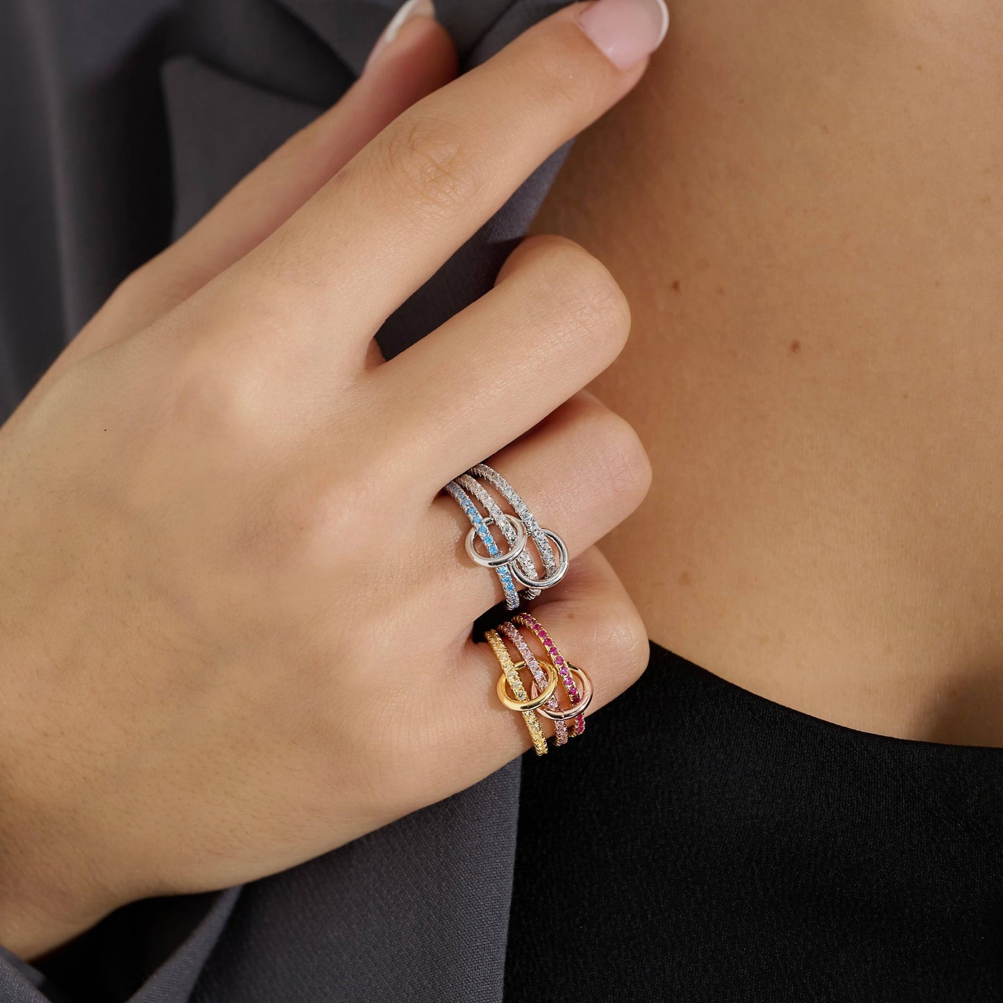 Sterling silver stacking ring with 3 layers of blue cubic zirconia paired with 18K Gold Vermeil ring with 3 layers of pink and yellow cubic zirconia.