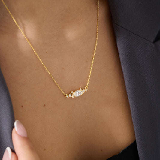 East-west marquise surrounded by round cubic zirconia on 18K gold vermeil.