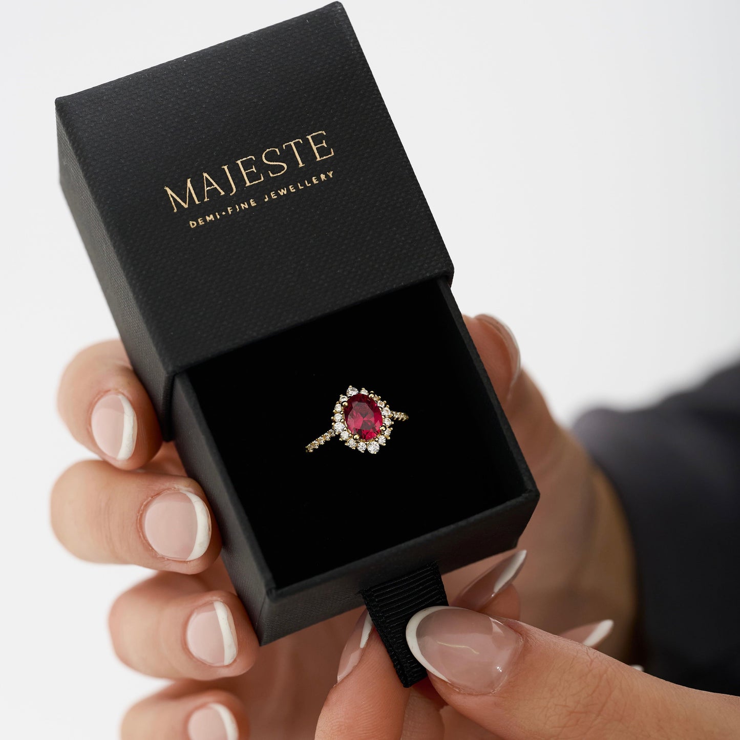 Ruby red gemstone with cubic zirconia halo and pave band on 18K gold vermeil.