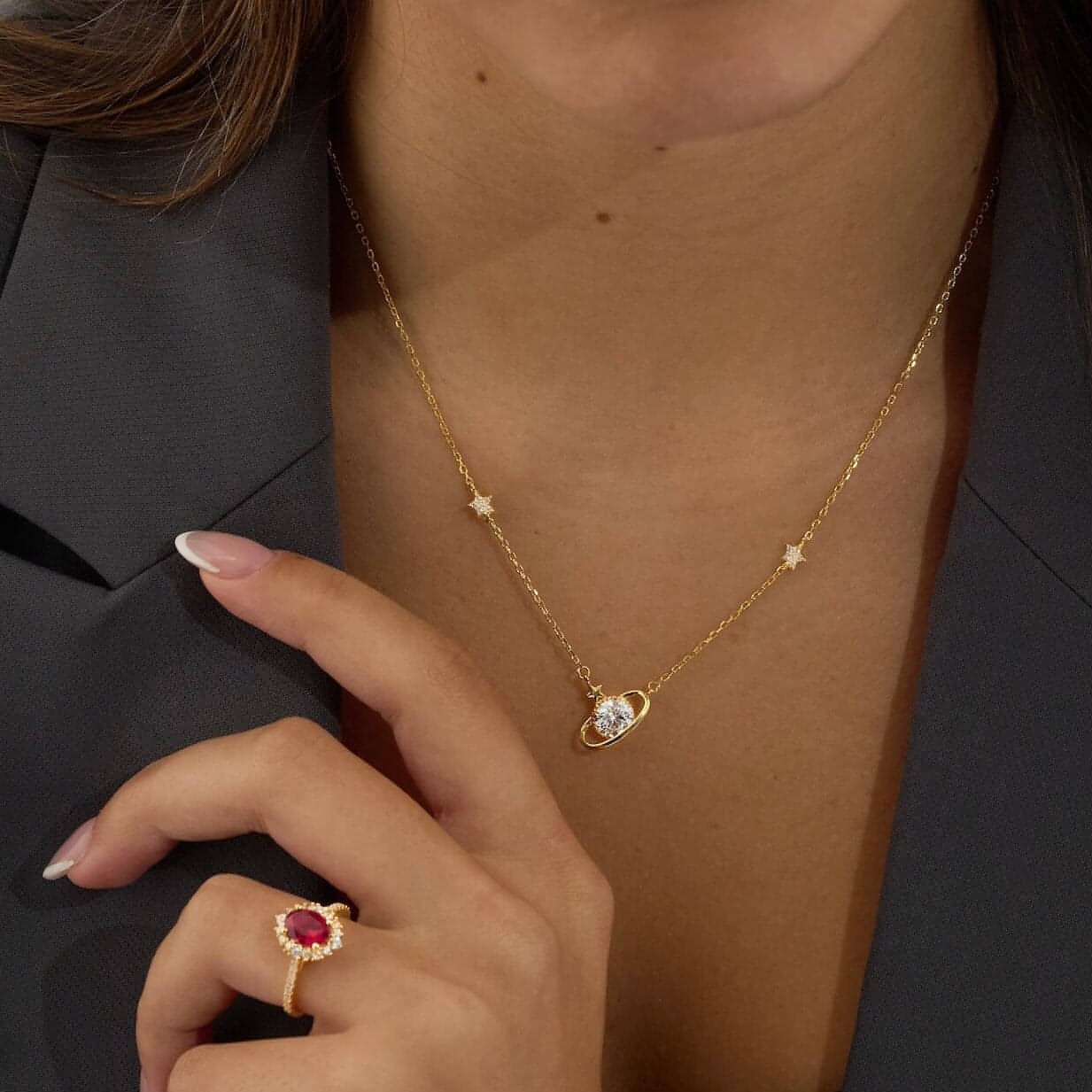 Ruby red gemstone with cubic zirconia halo and pave band on 18K gold vermeil paired with Saturn necklace with cubic zirconia centre in 18K gold vermeil.