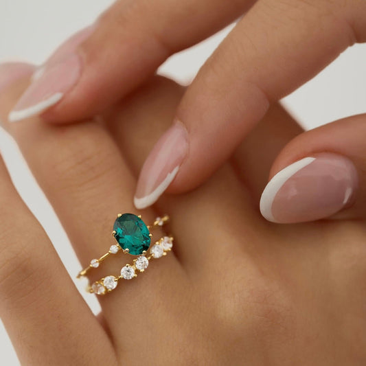 Emerald green oval gemstone set in 18K gold vermeil paired with half-eternity ring