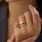 East west rectangle cubic zirconia with pave ring band stacked with half eternity cubic zirconia ring and half eternity rainbow ring. On pinky finger pink stacking ring will 3 layers. All in 18K gold vermeil.